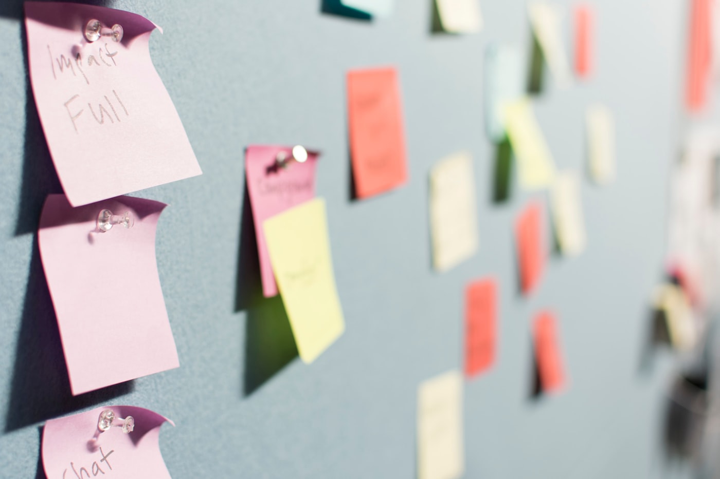 Rows of coloured sticky notes pinned across a board